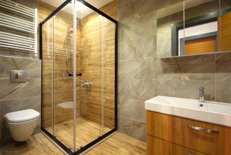 bathroom with walk in shower and sink