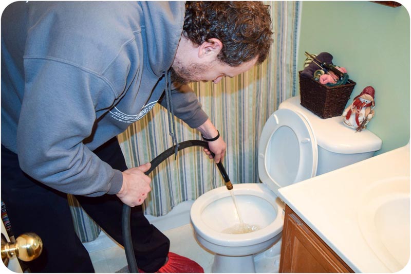 man filling toilet with water