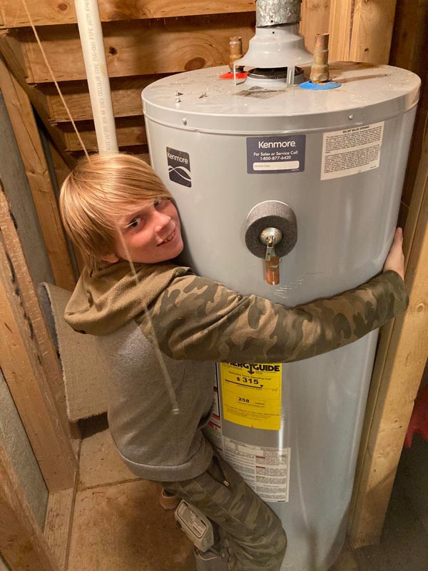boy hugging water heater